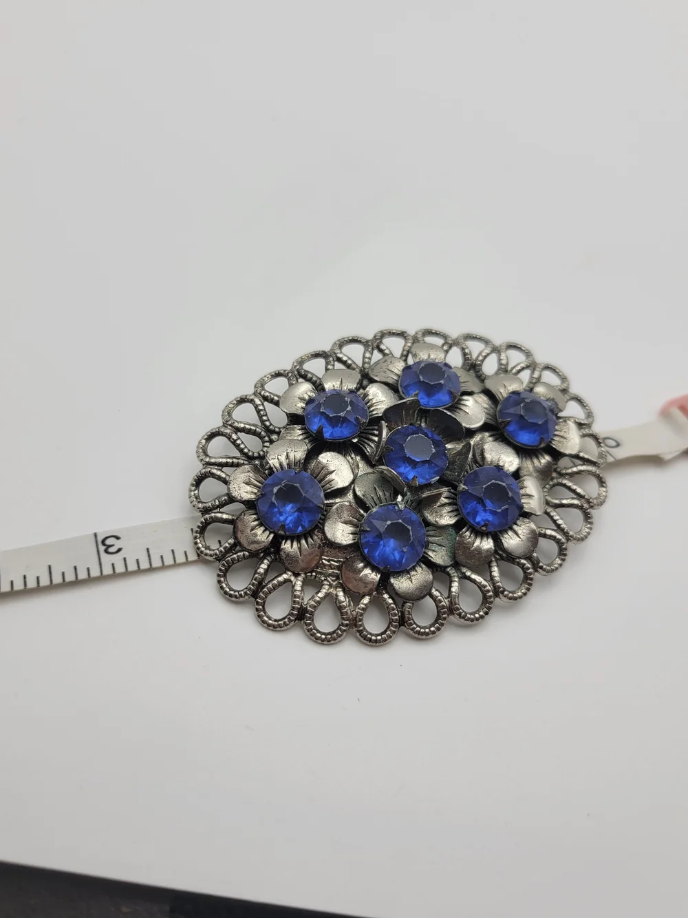 Vintage-Inspired Silver Floral Brooch with Blue Crystal Accents